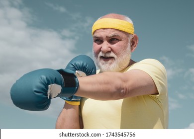 Best Cardio Workout. Elderly Man Hitting Punching Bag. Healthy Fighter Senior Old Man Boxing Gloves. Boxer With Boxing Glove. I Love Boxing. Handsome Elderly Man Practicing Boxing Kicks