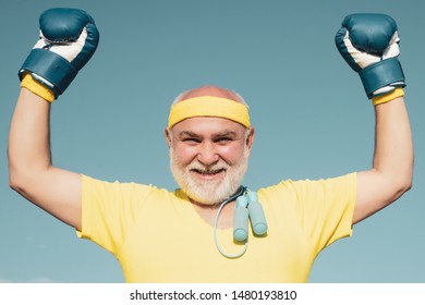 Best Cardio Workout. Happy Older Man Boxing - Close Up Portrait. Active Leisure. Senior Man In Gloves Beats Punching Bag. Senior Cool Man Fighting. I Love Boxing