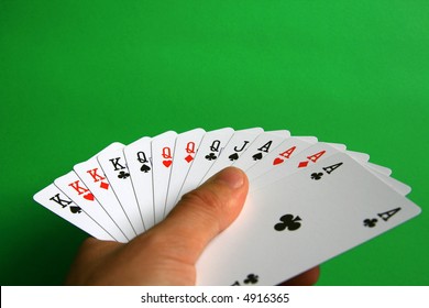 the best of cards in bridge...  It's incredible!  playing bridge - one hand (A,K,Q,J spades, A,K,Q hearts, A,K,Q diamonds, A,K,Q clubs)  background green,