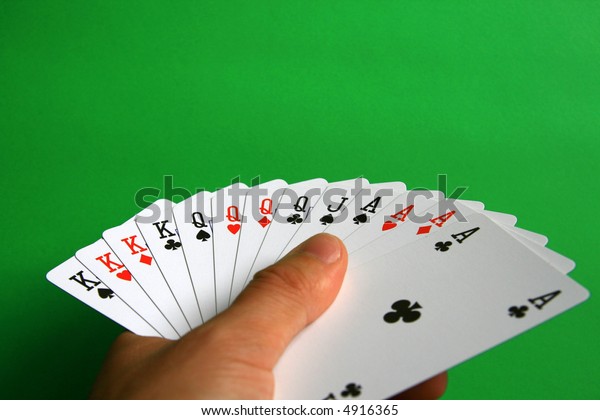 the best of cards in bridge...  It\'s\
incredible!  playing bridge - one hand (A,K,Q,J spades, A,K,Q\
hearts, A,K,Q diamonds, A,K,Q clubs)  background\
green,