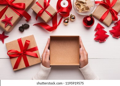 Best Christmas Gift. Woman Hands Holding Empty Craft Gift Box, Preparing Surprise For Holiday, Top View, Copy Space