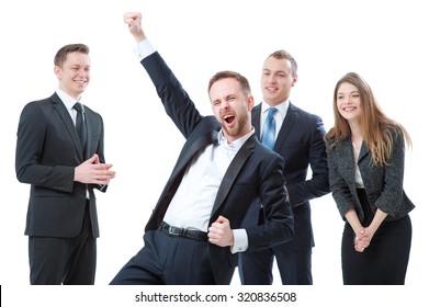 The best day ever! Business winner. Happy young bearded man in formal wear keeping arms raised and expressing positivity while his colleagues greeting him at the background. Isolated on white.