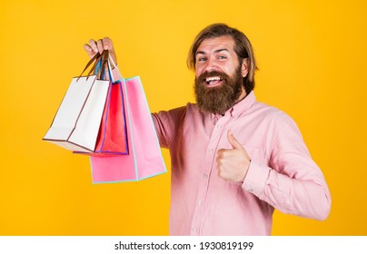 best day ever. mature hipster with beard hold present pack. brutal caucasian hipster with gift. male go shopping with purchase. successful shopaholic. bearded man ready for holiday. sale and discount.