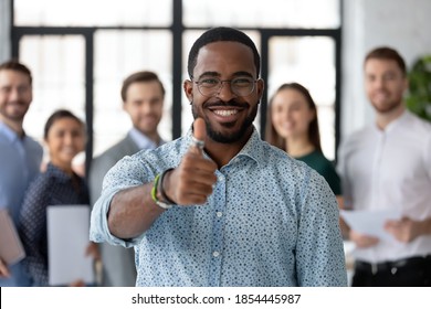 Best ever! Portrait of loyal excited black male client customer demonstrating thumb up sign recommending good product service, happy african employee looking at camera glad to work in company staff - Shutterstock ID 1854445987