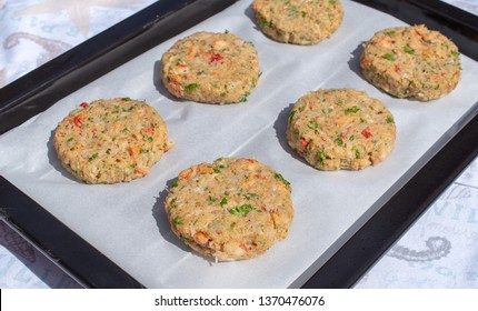 Best Fish Cakes Raw Uncooked On  Baking Tray. 
Row Of Crab Patties.