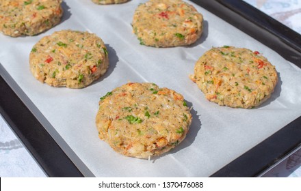 Best Fish Cakes Raw Uncooked On  Baking Tray. 
Row Of Crab Patties.