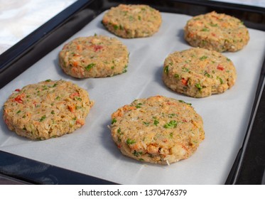 Best Fish Cakes Raw Uncooked On  Baking Tray. 
Row Of Crab Patties.