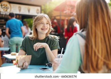 Best Friends Chatting On A Sunny Day Eating Tacos In Park Or A Faire, Smiling Rejoicing