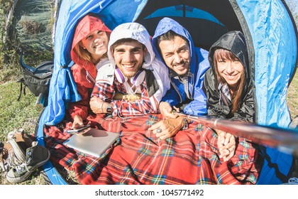 Best Friends Couples Taking Selfie At Camping Tent On Sunny Day After The Rain - Youth And Freedom Concept Outdoors In Spring Break Vacation - Young People Having Fun Traveling Together - Warm Filter