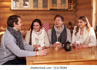 Best Friends Drinking Hot Tea In Cosy Kitchen At Winter Cottage.