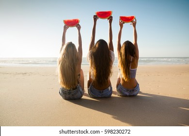 Best friends having fun on the beach and eating watermelon - Powered by Shutterstock