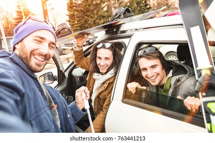 Best Friends Having Fun Taking Selfie At Car With Ski And Snowboard On Mountain Trip - Friendship Hangout Concept With Young People Loving Winter Sports Travel - Vintage Desaturated Contrast Filter