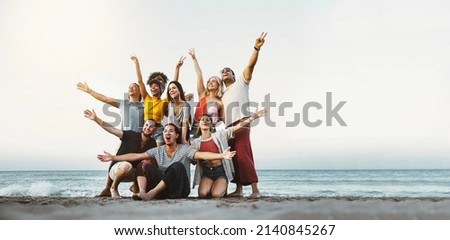 Best friends having fun together at the beach - Group of happy young people with arms up enjoying holiday outside - Teens enjoying spring break party - Summer vacations