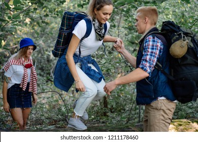 Best Friends Hiking With Nordic Sticks In The Forest, Overcoming Obstacles Together