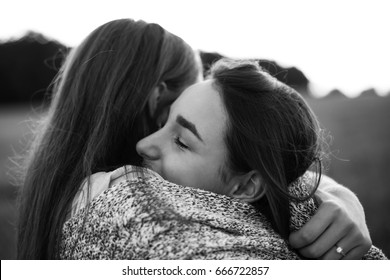 Best Friends Hug On The Field. Black And White. Close Up