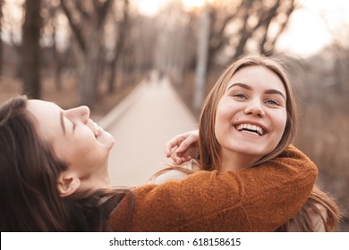 Best Friends Are Hugging Outdoors And Laughing. Best Friends