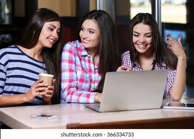 Best Friends With Laptop Together Sitting In Cafe