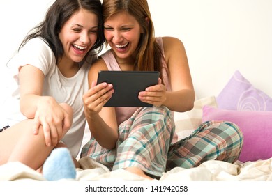 Best Friends Laughing Loudly Browsing Social Network