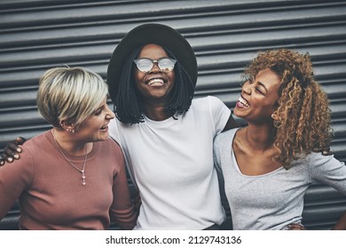 Best Friends Are Made For Laughter. Shot Of A Diverse Group Of Female Friends Embracing Each Other Outside.