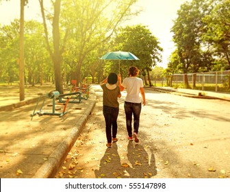 Best Friends Sharing Umbrella