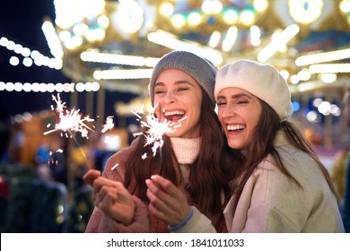 Best friends with sparklers on Christmas market - Powered by Shutterstock