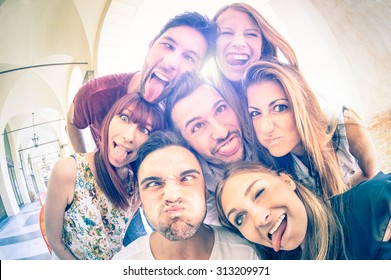 Best Friends Taking Selfie Outdoors With Backlighting - Happy Friendship Concept With Young People Having Fun Together - Cold Vintage Filtered Look With Soft Focus On Faces Due To Sunshine Halo Flare