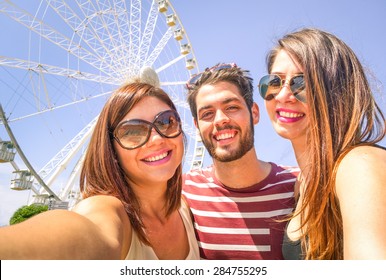 Best Happy Friends  With Mobile Taking Selfie At Ferris Wheel - Three Students At Luna Park - Concept Of Friendship And Fun With New Trend And Technology - Young People Enjoy With Modern Smartphone