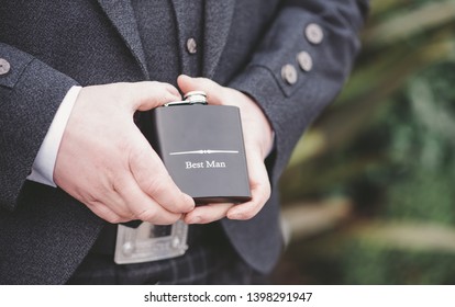 Best Man and Ushers hold hip flasks on wedding day