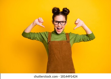 I'm best. Photo of crazy student lady two buns direct fingers herself open mouth excited mood personal branding wear specs green pullover brown overall dress isolated yellow color background