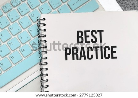 Best practice text on notebook with keyboard background for business strategy and professional standards concept.