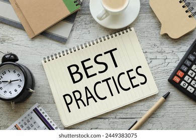 best practice text on a notepad with a spiral. cup of coffee
