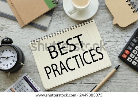 best practice text on a notepad with a spiral. cup of coffee