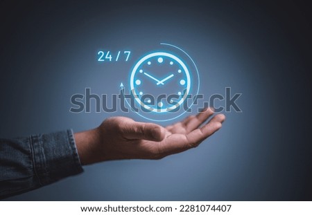 Best service mind concept. Businessman hand holding virtual analog clock with word 24-7 for worldwide nonstop and full-time available contact of service concept. Ready customer service support team.