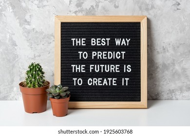 The best way to predict the future is to create it. Motivational quote on letter board, cactus, succulent flower on white table. Concept inspirational quote of the day. Front view.