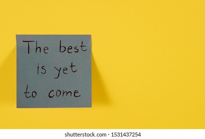 The Best Is Yet To Come. Blue Sticky Note With Inspirational Quote On Neon Yellow. Handwritten Positive Reminder/advice. Concept For Confidence, Courage And Motivation. Sign Of Moral Support.
