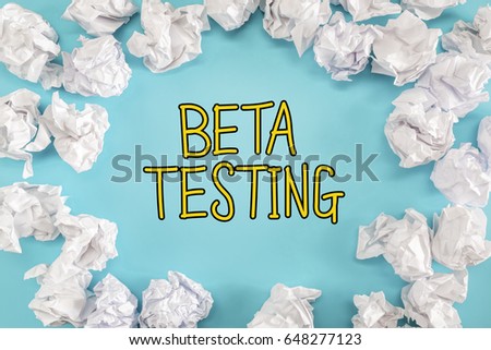 Beta Testing text with crumpled paper balls on a blue background