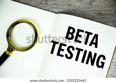 Beta Testing text written on chalkboard with alarm clock on wooden background
