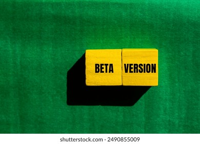 Beta version message written on yellow wooden cubes with green background. Conceptual beta version symbol. Copy space.