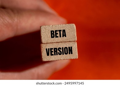 Beta version message written on wooden blocks with orange background. Conceptual beta version symbol. Copy space.