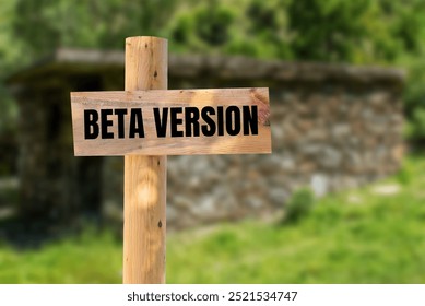 Beta version message written on wooden sign with nature background. Conceptual beta version symbol. Copy space.