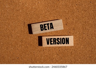 Beta version words written on wooden blocks with brown background. Conceptual beta version symbol. Copy space.