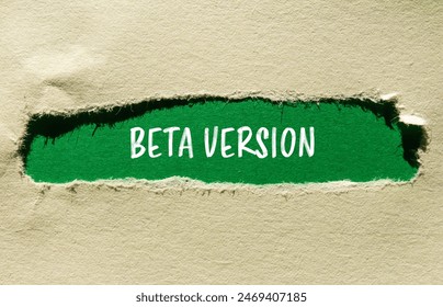 Beta version words written on ripped paper with green background. Conceptual beta version symbol. Copy space.