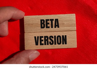 Beta version words written on wooden blocks with red background. Conceptual beta version symbol. Copy space.