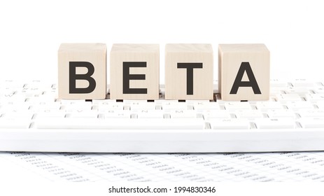BETA -word wooden block on keyboard background witn chart