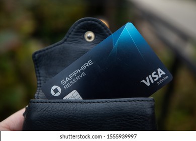 Bethesda, MD / USA - Nov. 10, 2019: A Hand Holds A Chase Sapphire Reserve Credit Card, Which Gives Users Points Towards Travel Credit And Priority Pass Airport Lounge Access.