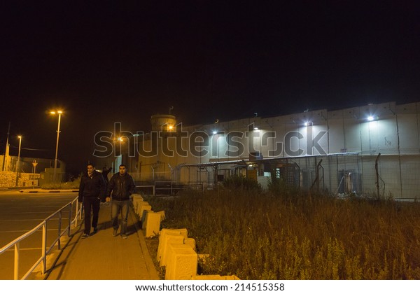 BETHLEHEM, PALESTINE - January 2: Unidentified people\
passing the wall between Israel and Palestine on Januray 2, 2013 in\
Bethlehem, Palestine.\
