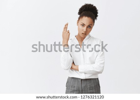 Better kill myself than hear you. Portrait of intense annoyed and bored beautiful dark-skinned female model with curly hair raising fingergun near temple and making shot as if commiting suicide