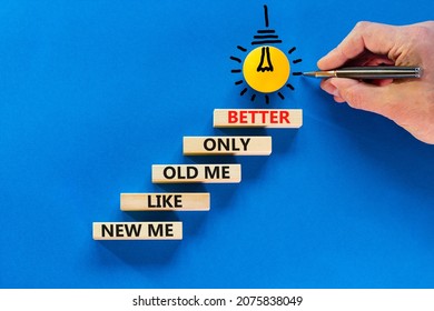 Better new me symbol. Wooden blocks with words 'new me like old me only better'. Light bulb icon. Businessman hand, pen. Beautiful blue background, copy space. Business and better new me concept.