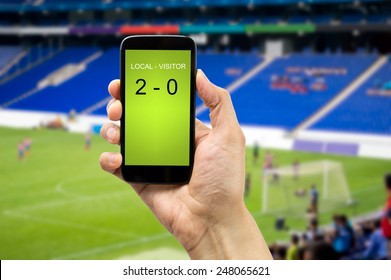 Betting Man Through His Smart Phone In A Stadium