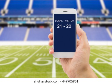 Betting Man Through His Smart Phone In A American Football Stadium